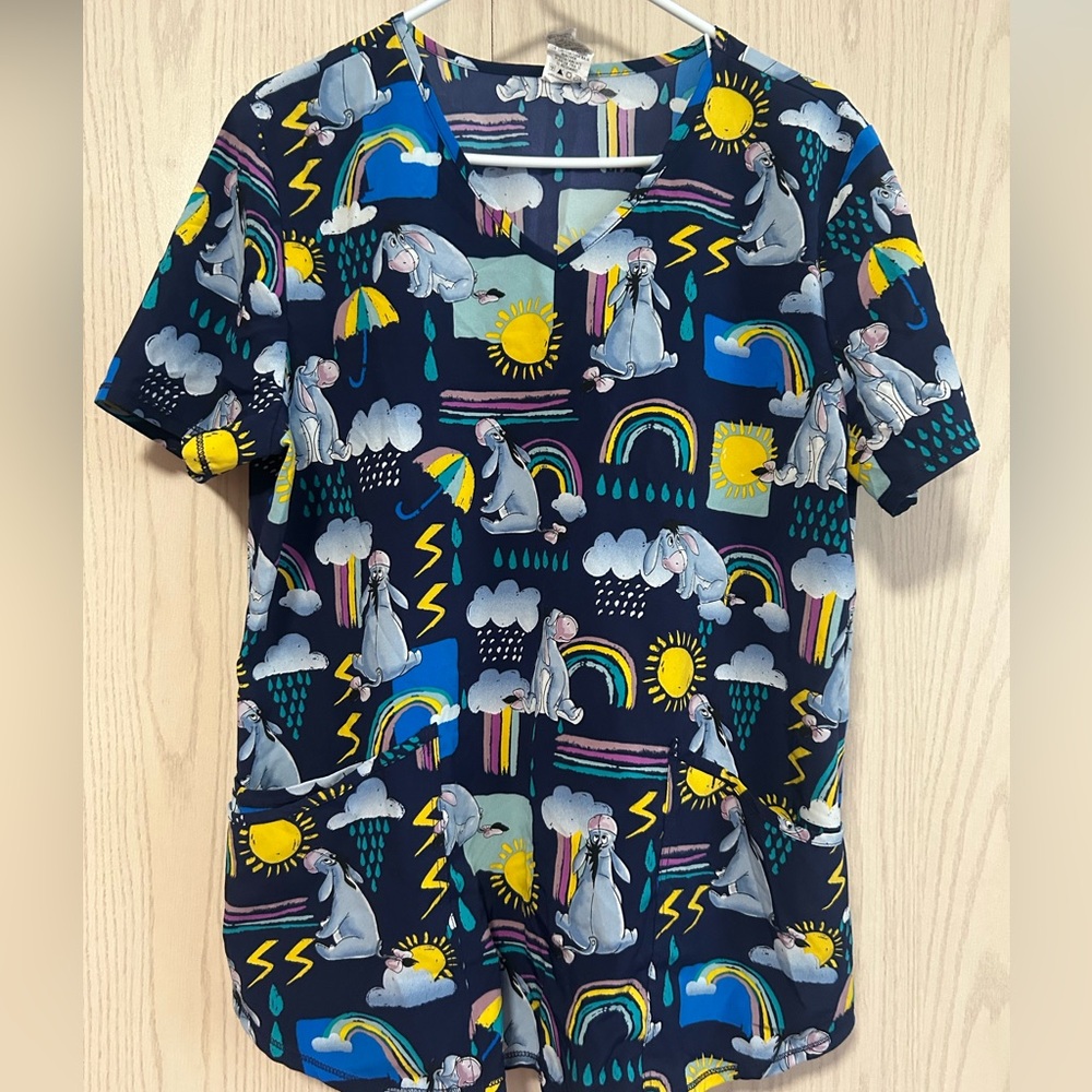 Disney Navy scrub Top with Rainbow & Sun Graphic Eeyore